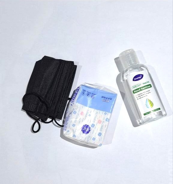Social Work Day 2025 – What's inside a social worker’s bag 3 A black mask folded in half, a small packet of tissue paper and a small bottle of hand sanitiser.