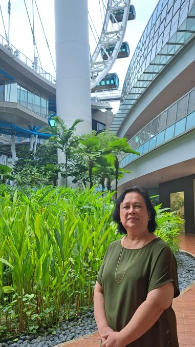 Building an Inclusive Workforce: Singapore Flyer’s Commitment to Diversity 2 Mdm Yati with part of the Singapore Flyer in the background