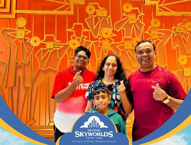 Chandra with his wife and 2 sons in a Genting Skyworlds template photograph 
