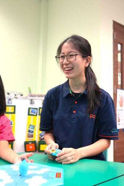 How SPD’s Early Intervention Teachers Relax and Recharge during the School Holidays 2 Jean smiling and seated in her classroom