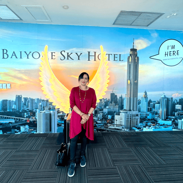 How SPD’s Early Intervention Teachers Relax and Recharge during the School Holidays 3 Sara in front of a mural with text Baiyoke Sky Hotel