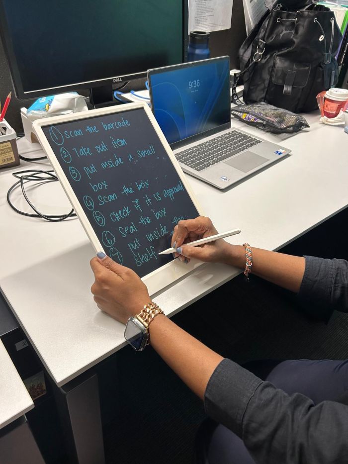What’s inside their bags? - Employment support professionals' edition 2 Andrea writing on her LED writing pad