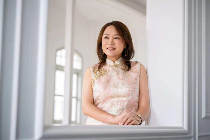 Educating with Heart: How Wang Learning Centre is Shaping a Kinder Generation 1 Mdm Wang Jie in a beige cheongsam