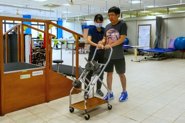 Celebrating Excellence: Lasting Impact of a Community Therapist – Pauline Koh 2 Pauline guides a client on strength training exercises.
