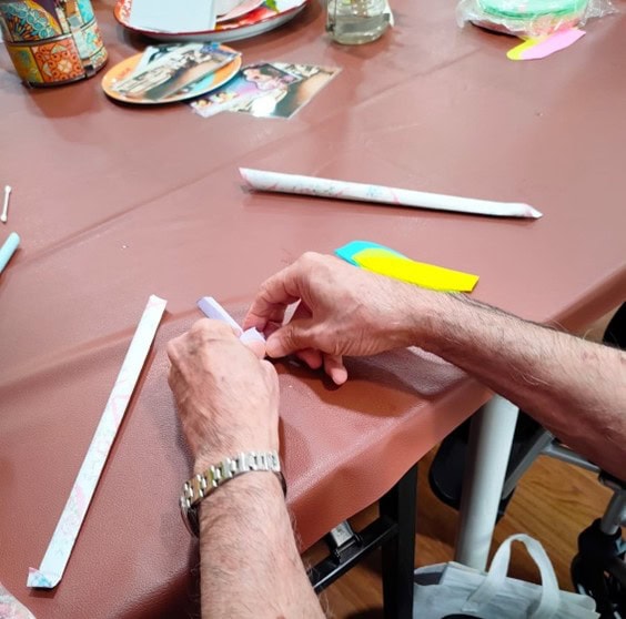 A pair of hands working on a paper chapteh.