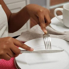 How Practice Helps the Brain Recover After a Stroke 4 A person using a knife and fork on a plate.