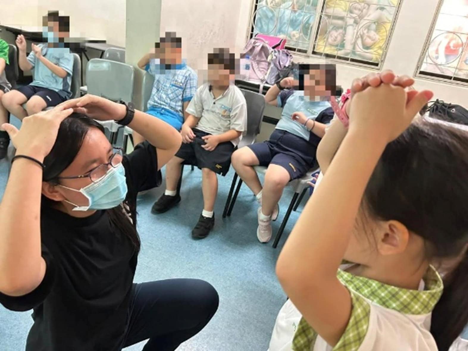 Turning Self-Doubt into Purpose, Youth with Vision Loss Hopes to Help Others Find Strength 1 Cindy as a volunteer teaching assistant guiding a child in putting her hands on her head.