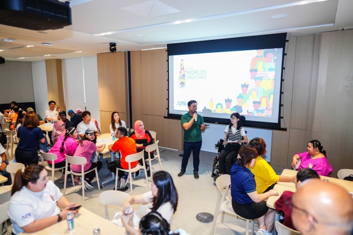 Building Worlds Together: How SPD and APB Singapore are Co-creating Inclusion 2 Winston and Raphaella addressing the participants inside an activity room
