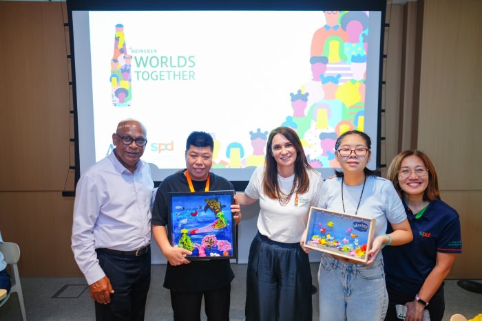 Building Worlds Together: How SPD and APB Singapore are Co-creating Inclusion 6 Chang Hui and another E S H client presenting handicraft artwork to an A P B S representative. They are flanked by S P D C E O Mr Abhimanyau Pal and A C E O Ms Tay Soong Kiang.