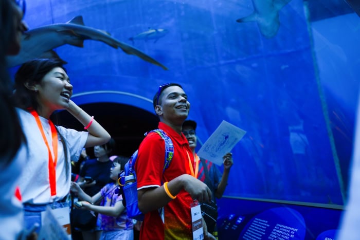Building Worlds Together: How SPD and APB Singapore are Co-creating Inclusion 4 A participant accompanied by a volunteer happily admiring the fish