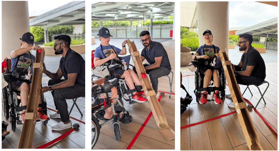 Strength in Community: Living with vision and hearing loss, youth volunteer supports others through boccia 3 Vinid helping a client position the ramp during a Boccia session