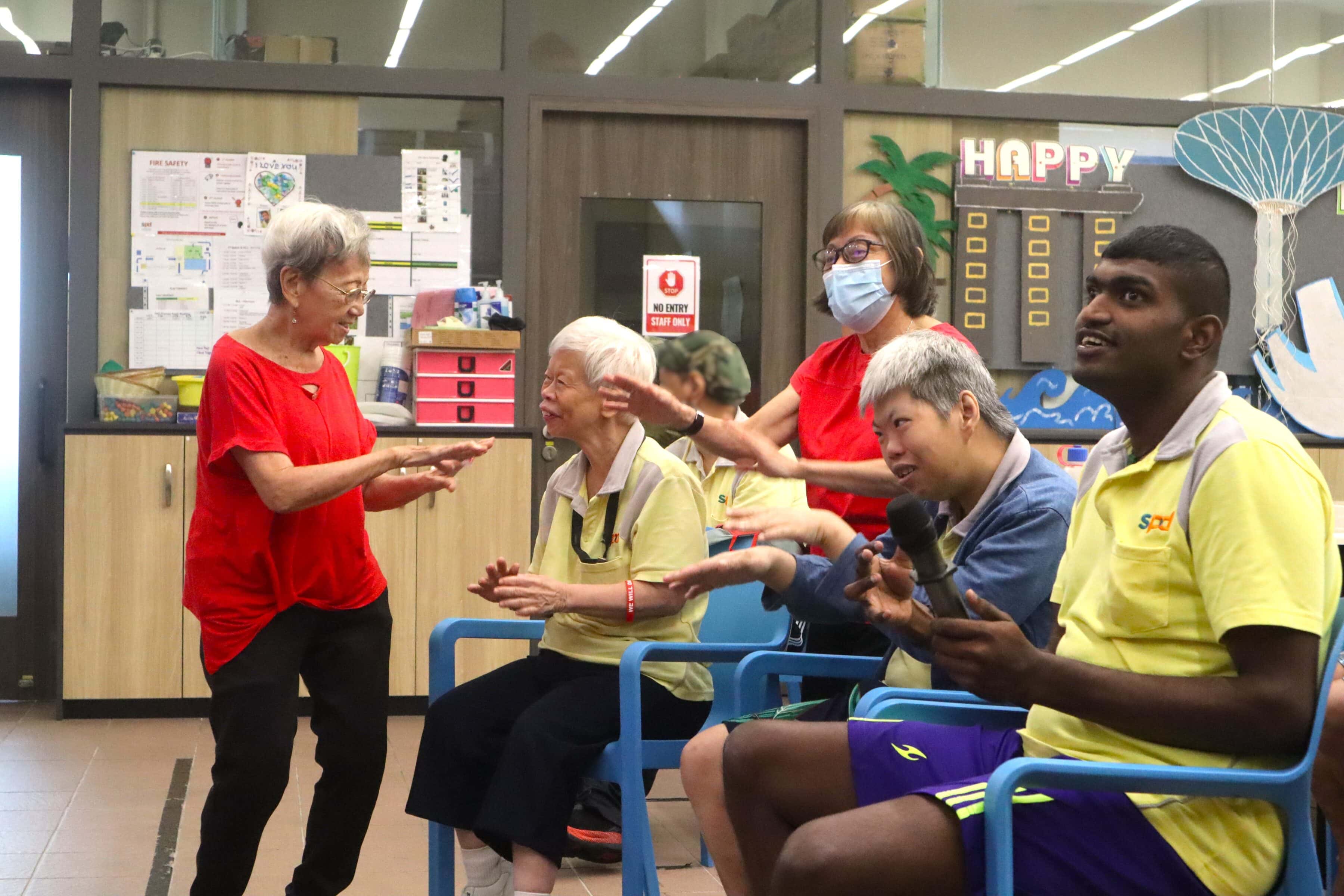 A Heart That Never Grows Old: Auntie Molly’s volunteer journey with SPD 9 Auntie Molly interacting with some D A C clients in a sing-a-long session