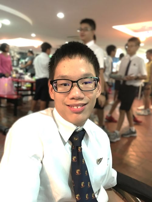 A younger Zachary in school uniform in the school canteen