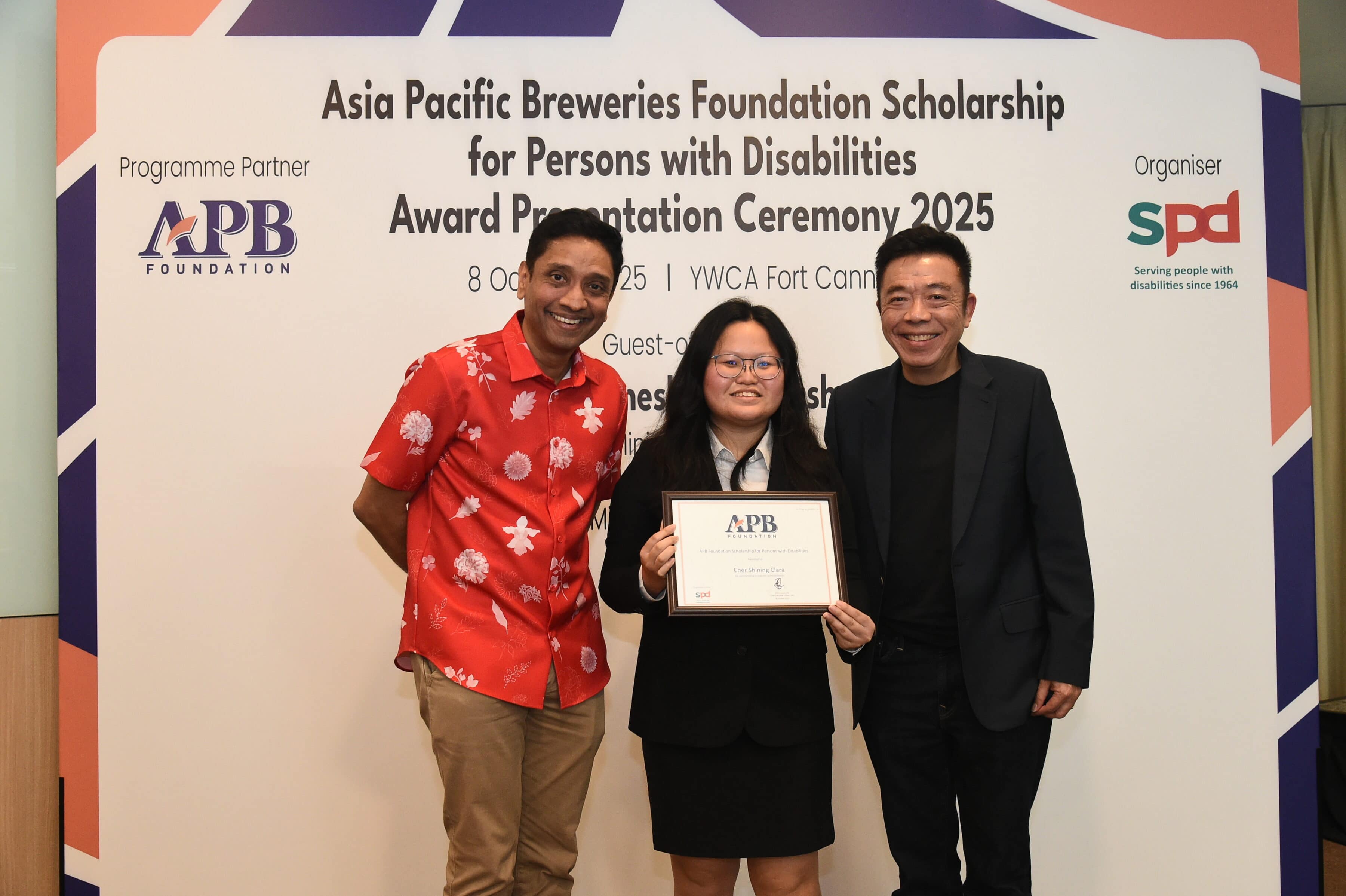 Silence to Strength: How Clara is finding her voice to advocate for inclusion 2 Clara at the APB Foundation Scholarship award ceremony with Guest-of-Honour Mr Dinesh Vasu Dash, Minister of State for Culture, Community and Youth & Ministry of Manpower, and Mr Kenneth Choo, Chairman, Board of Trustees, APB Foundation and Managing Director, HEINEKEN Asia Pacific.