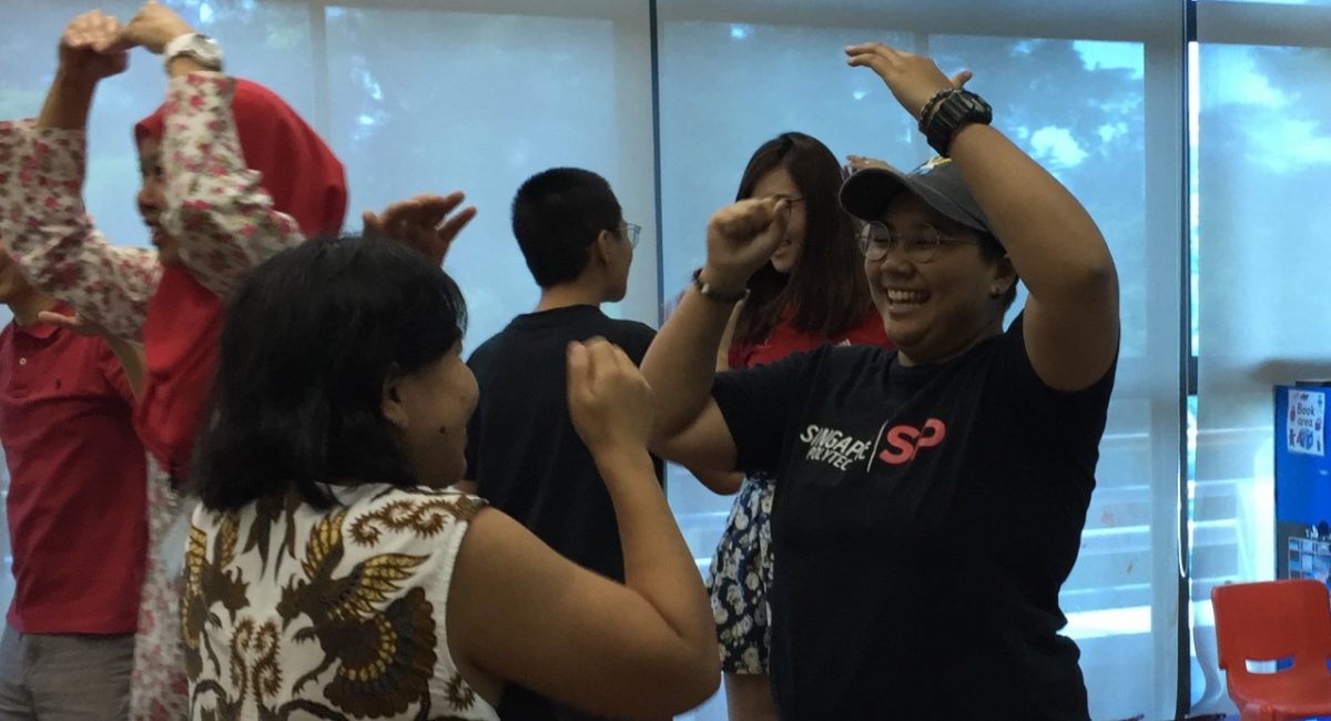 Students and caregivers having fun during the ice breaker game.
