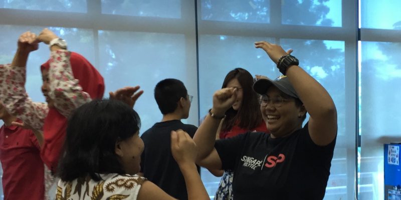 Students and caregivers having fun during the ice breaker game.