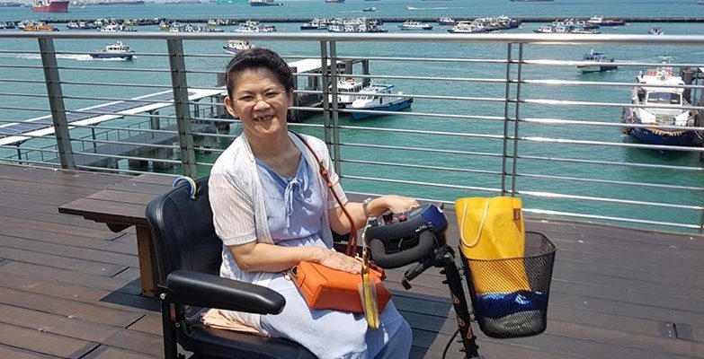 Bee Lian going outdoors on her motorised scooter