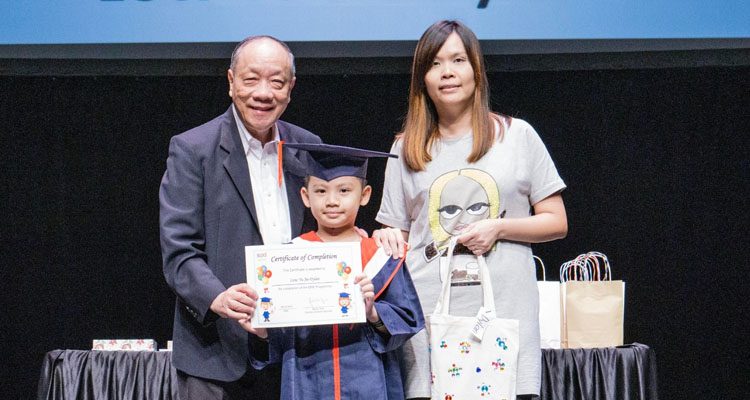An EIPIC graduate receiving his certificate from SPD Board Member, Professor Ho Lai Yun (left)