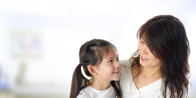 Mother having conversation with daughter
