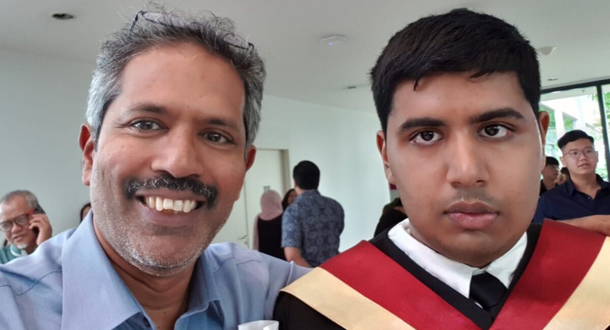 Mr Rajendran beside Kirisnah who is wearing his graduation gown