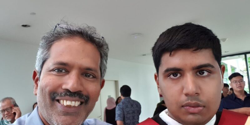 Mr Rajendran beside Kirisnah who is wearing his graduation gown