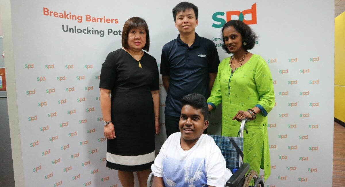 NatSteel staff with Empowerment Award recipient Madan and his mum