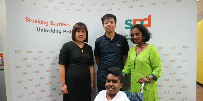 NatSteel staff with Empowerment Award recipient Madan and his mum