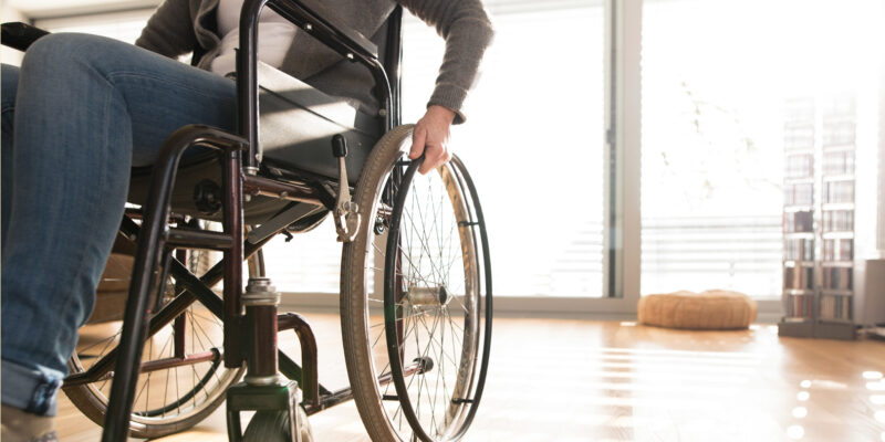 Person using a wheelchair in a room