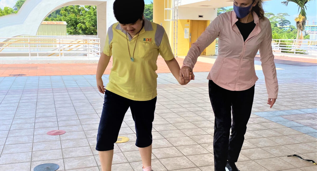 Aimee holding Mei Mei's hand