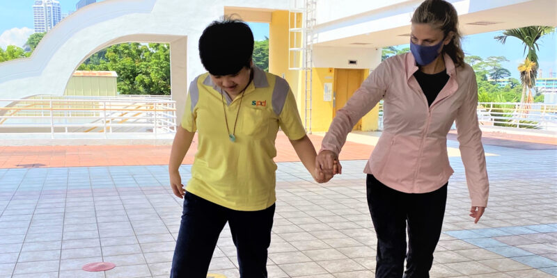 Aimee holding Mei Mei's hand