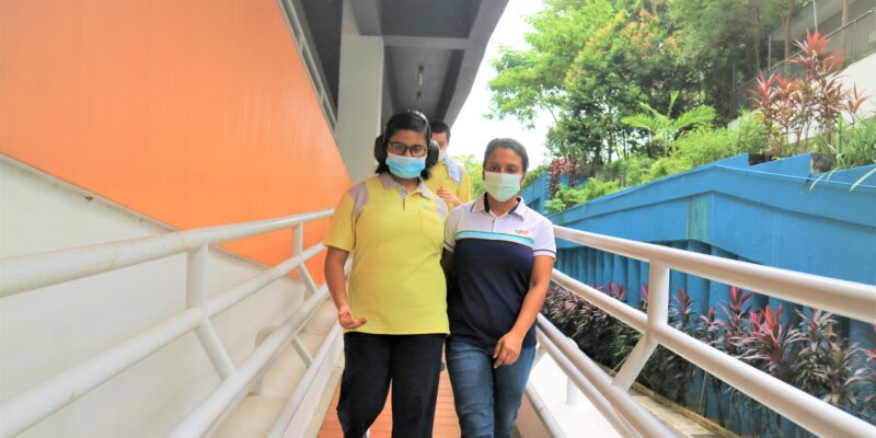 S P D training officer walking with a Day Activity Centre client