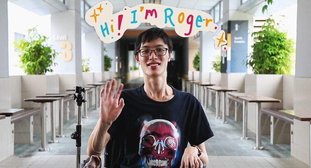Roger in his wheelchair waving