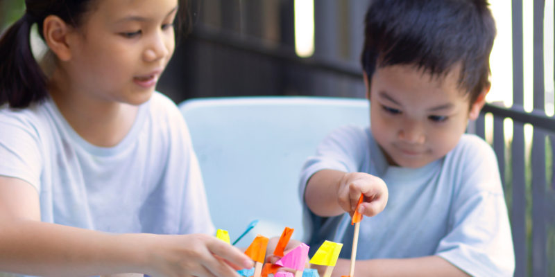 Two kids engaging in a colour-matching activity