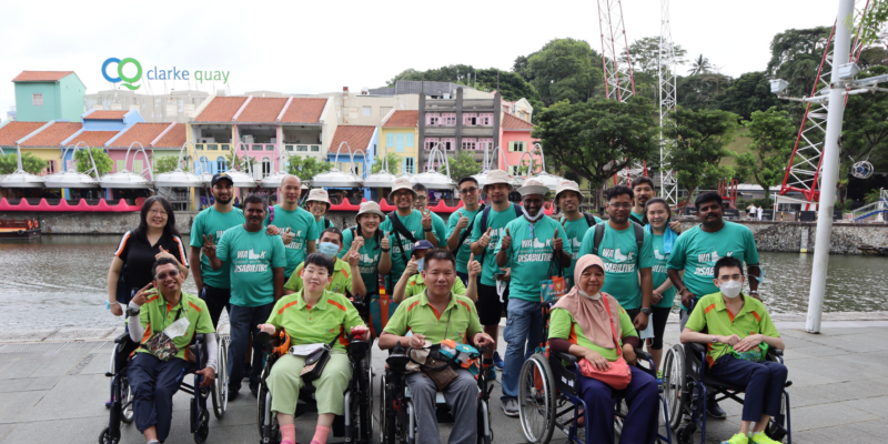 A photo of S P D volunteers, staff and trainees at an outdoor event