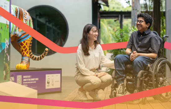 A volunteer positioning herself beside a wheelchair user, both smiling