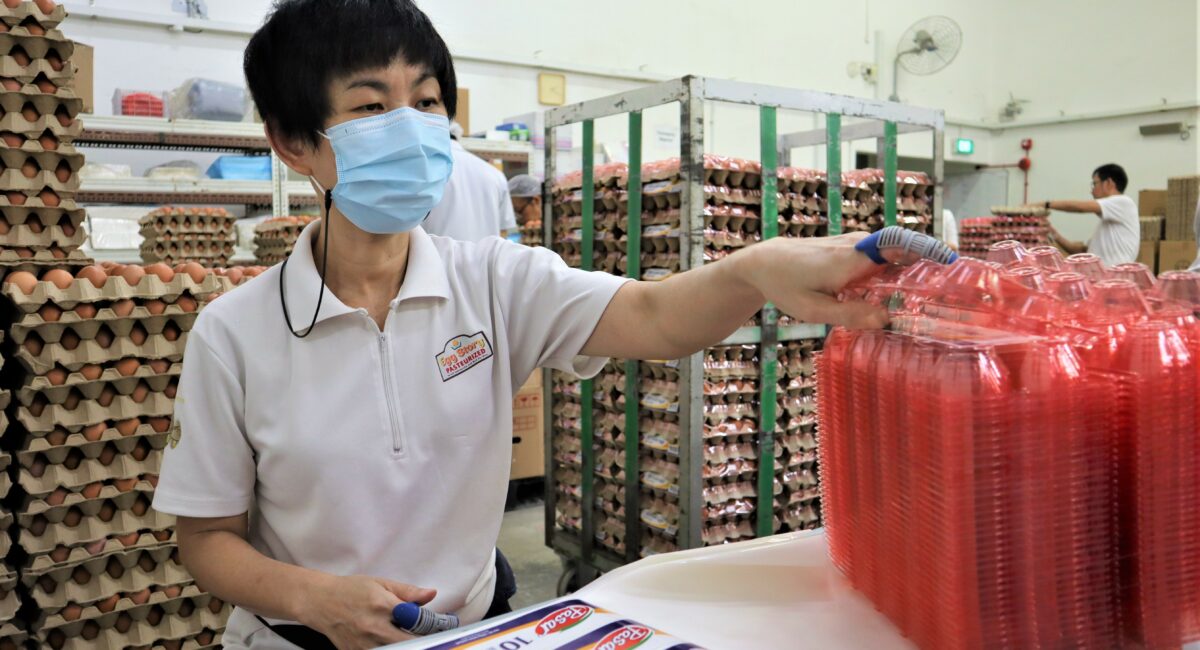 A woman with disability labelling egg cartons