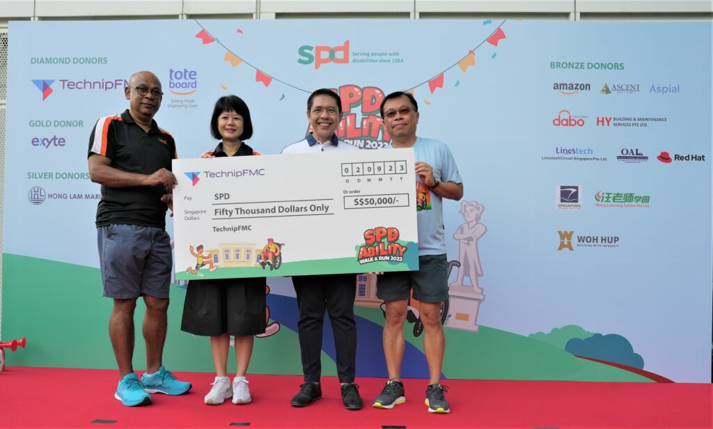 Cheque presentation from TechnipFMC to SPD. From left: Mr Abhimanyau Pal, SPD CEO; Ms Ong Toon Hui, SPD President; Guest-of-honour Dr Maliki Osman; Mr Roger Tan, Vice President - Manufacturing Operations at TechnipFMC Singapore.