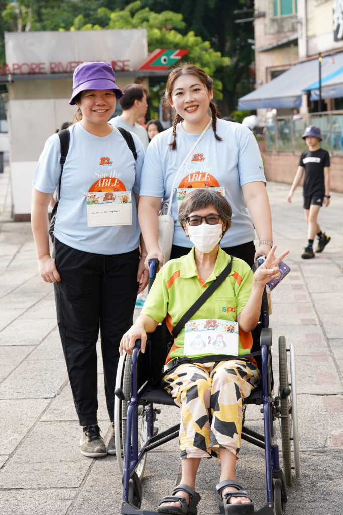 Sheltered Workshop trainee Mdm Pang Lee Lee with corporate volunteers.