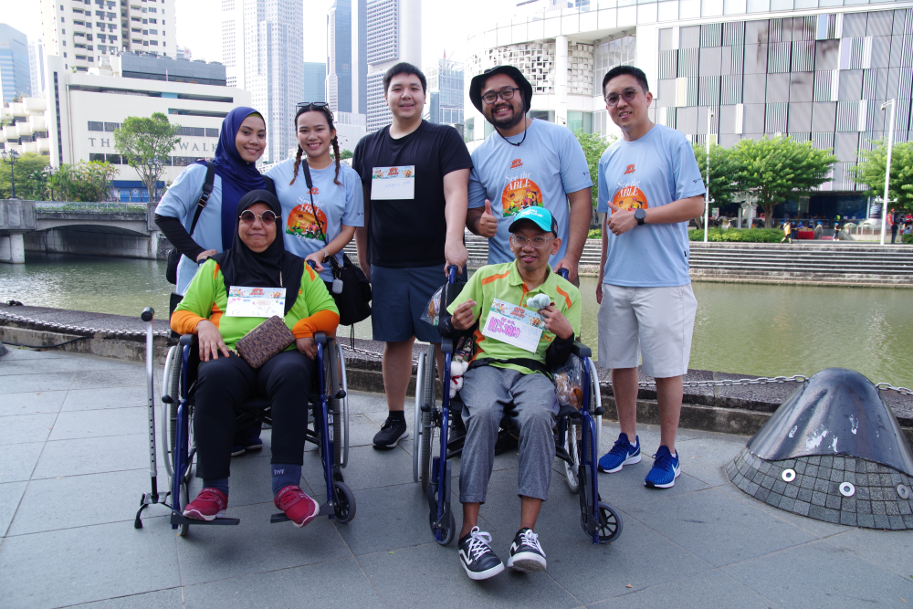 Sheltered Workshop trainees Mdm Hamidah Binte Wahab and Mr Norhissam Bin Kusaeni with corporate volunteers.