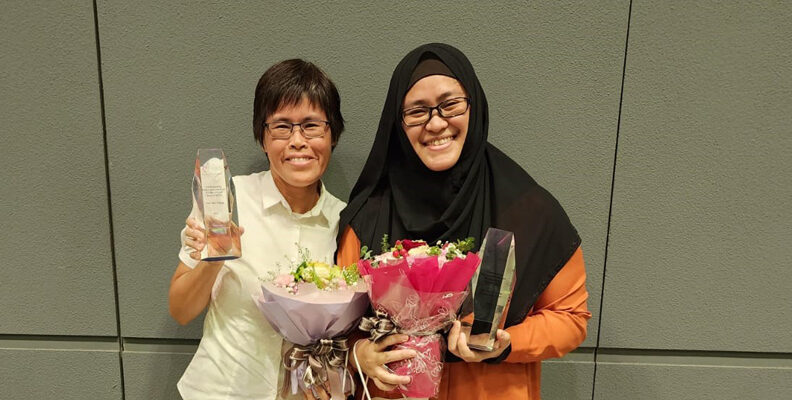 Senior learning support educators Yap Wai Ching and Nor Jannah Binte Muhammad Sabri smiling and holding their ECDA Awards and flowers