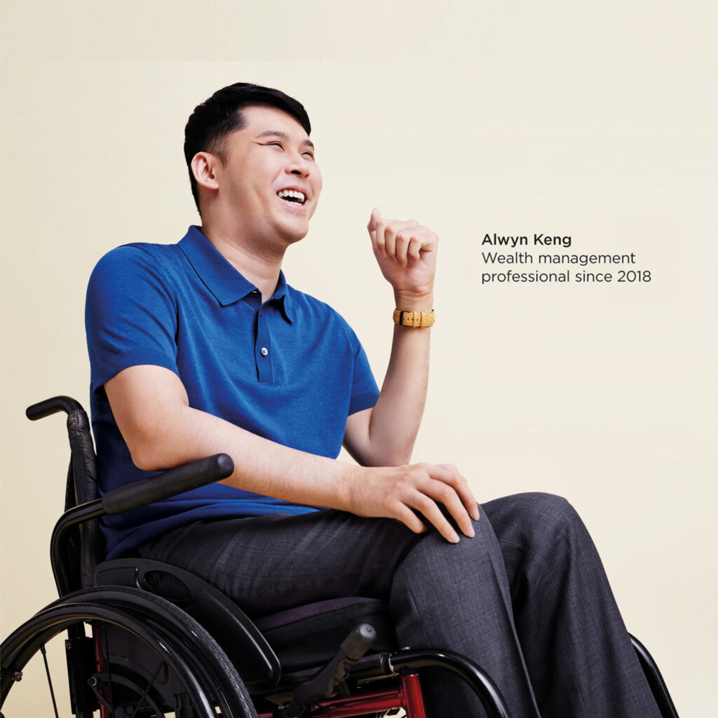 Alwyn seated in his wheelchair, smiling