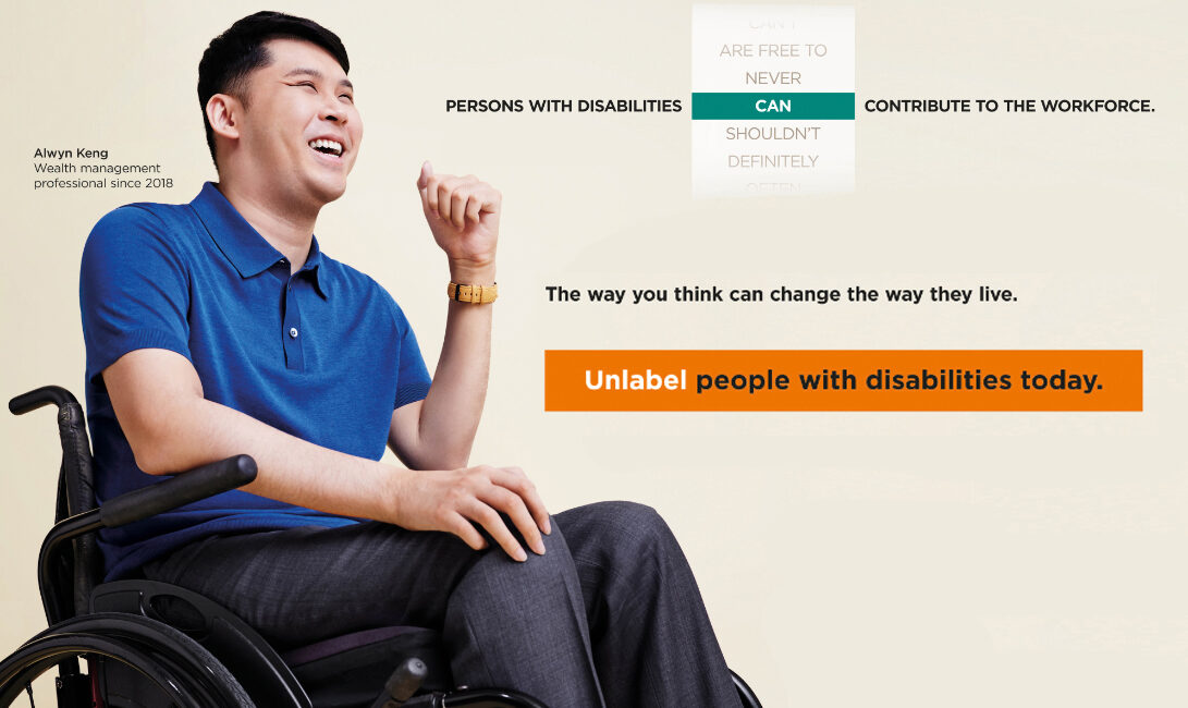 Alwyn in blue collared tee seated in his wheelchair smiling. Tagline People with disabilities can contribute to the workforce. Unlabel people with disabilities today.