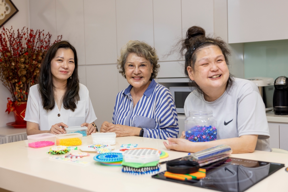 Fion, Mdm Lydia and Veronica doing a craft activity together at the ESH.