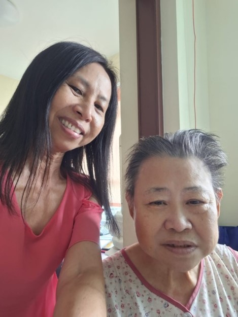 SPD volunteer Josephine with 71-year-old Mdm Regina Ko, noth smiling