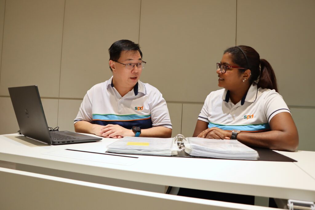 Kian Meng in a discussion with occupational therapist Lavanitha
