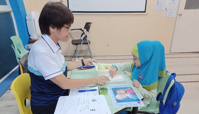 Wai Ching conducting a literacy assessment with one of the students