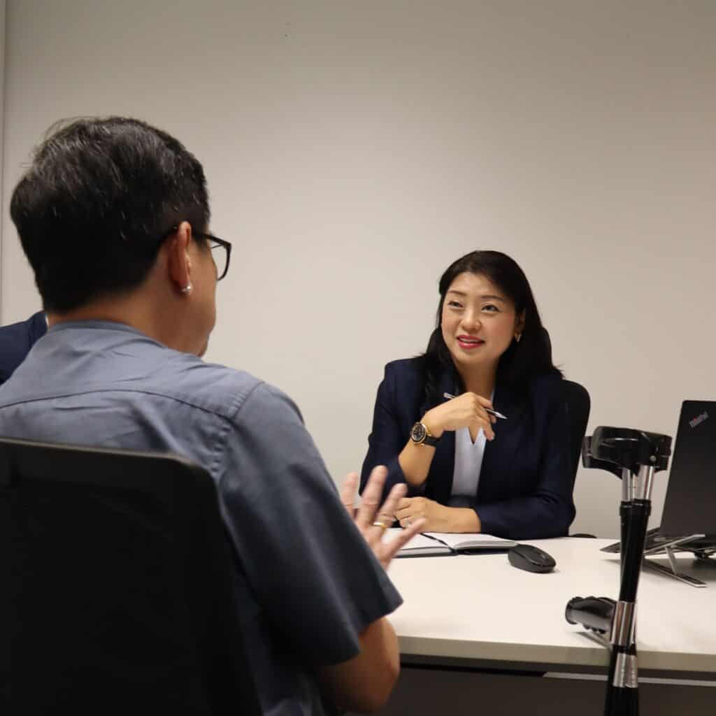 Founder of MCS Advisory Group Ms May Chan listens intently to Mr Chong