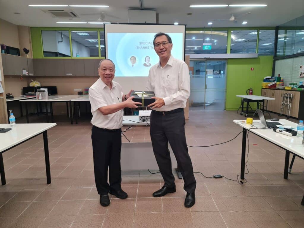 A man presenting a token of appreciation to another man