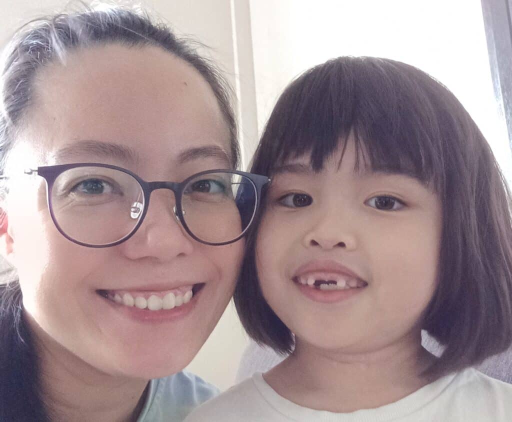 A lady and her daughter smiling for the camera