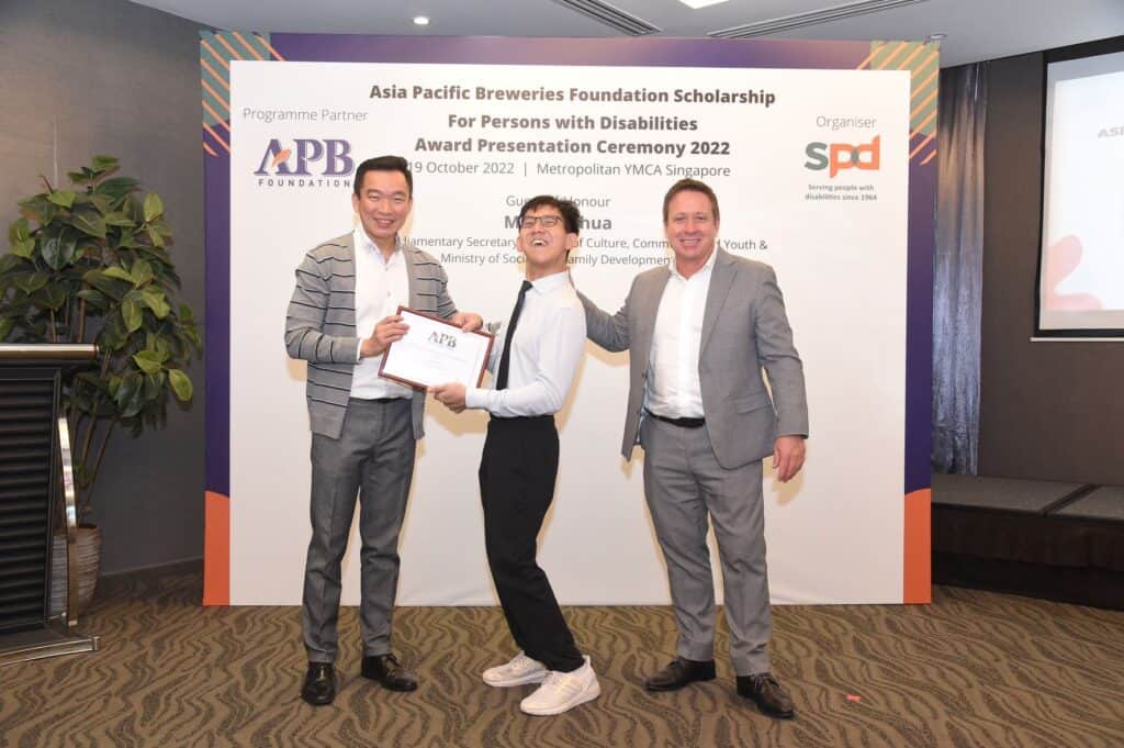 Matthew receiving the scholarship from Guest of Honour Mr Eric Chua and Member, Board of Trustees, Asia Pacific Breweries Foundation and Managing Director, Asia Pacific Breweries (Singapore) Mr Andy Hewson, 